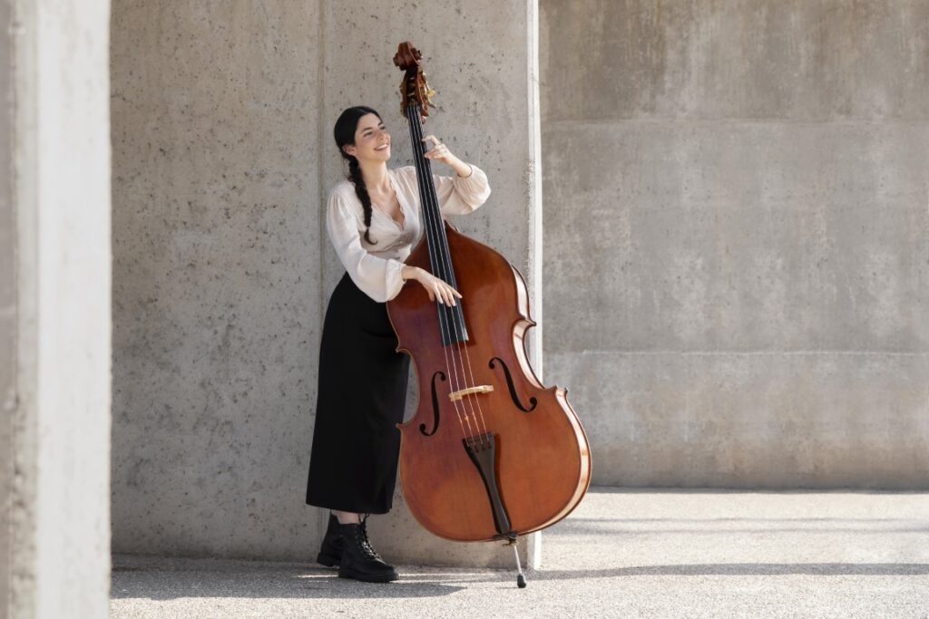 full shot woman with double bass Medium